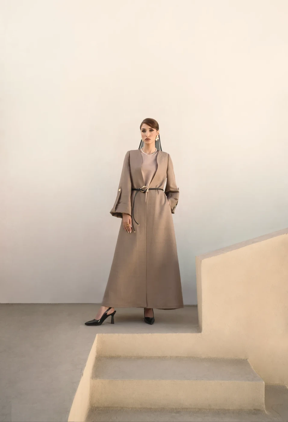 Taupe coat dress on studio stairs