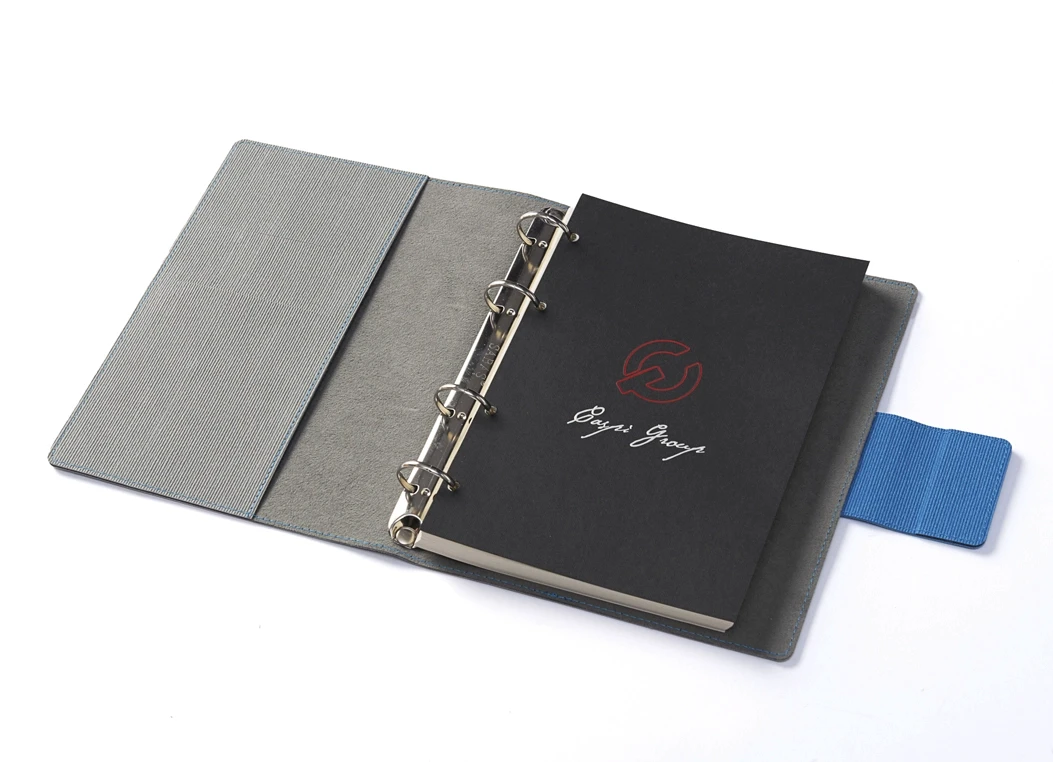 Open textured ring binder journal with metal rings and black title page