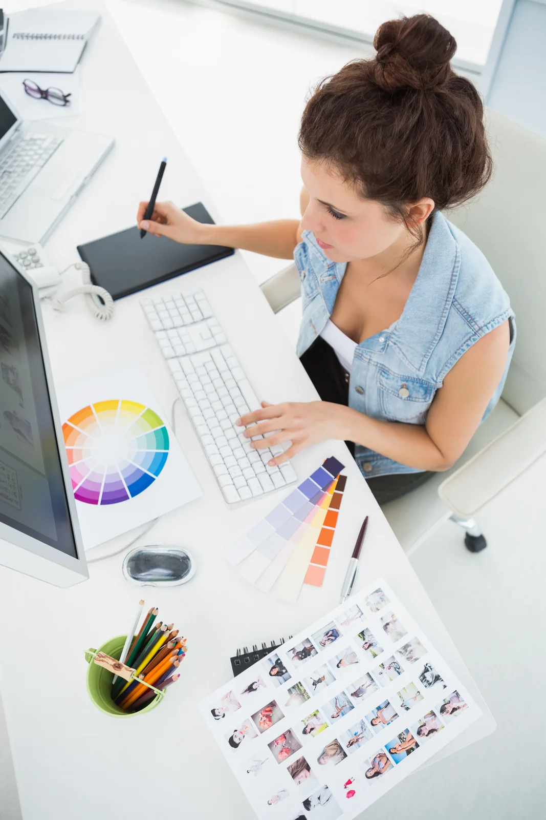 Woman Designs with Graphics Tablet in Bright Office
