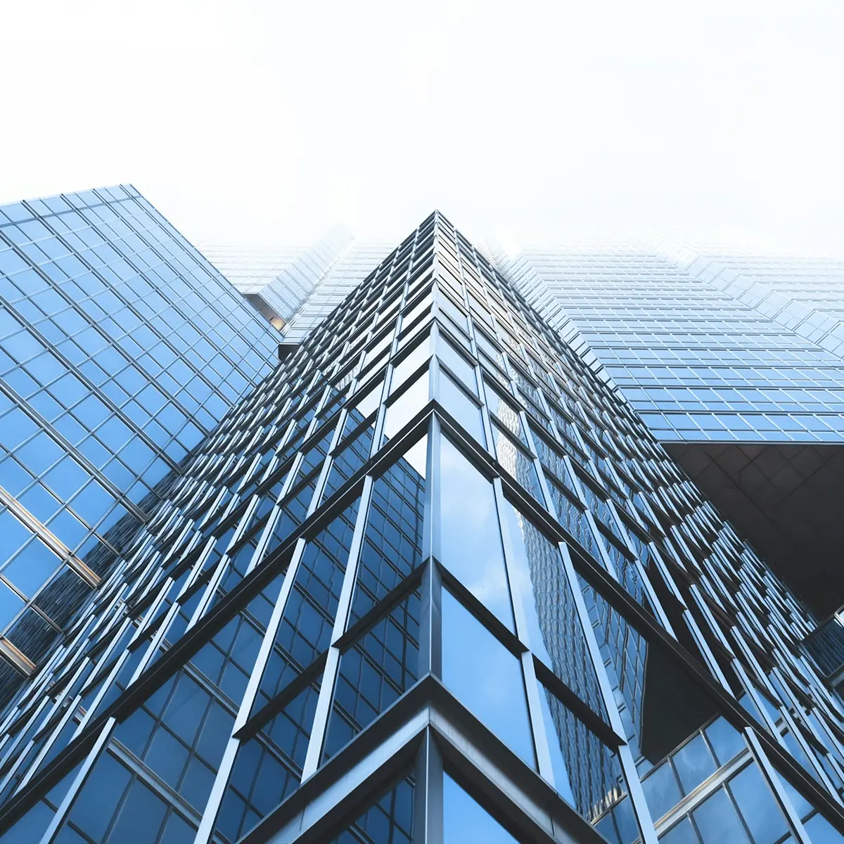 Low-angle view of modern glass skyscrapers.