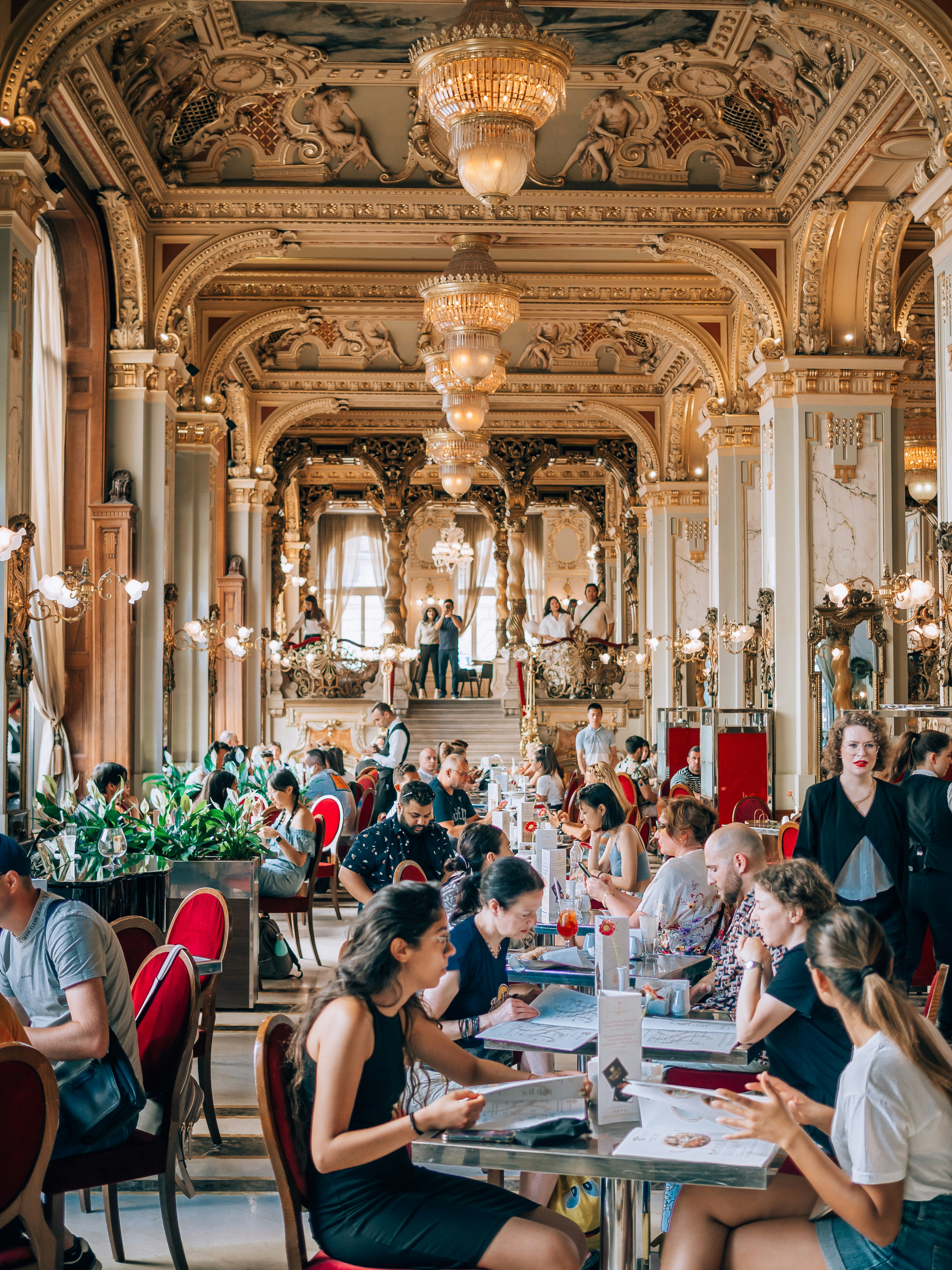Ornate grand café dining room filled with guests