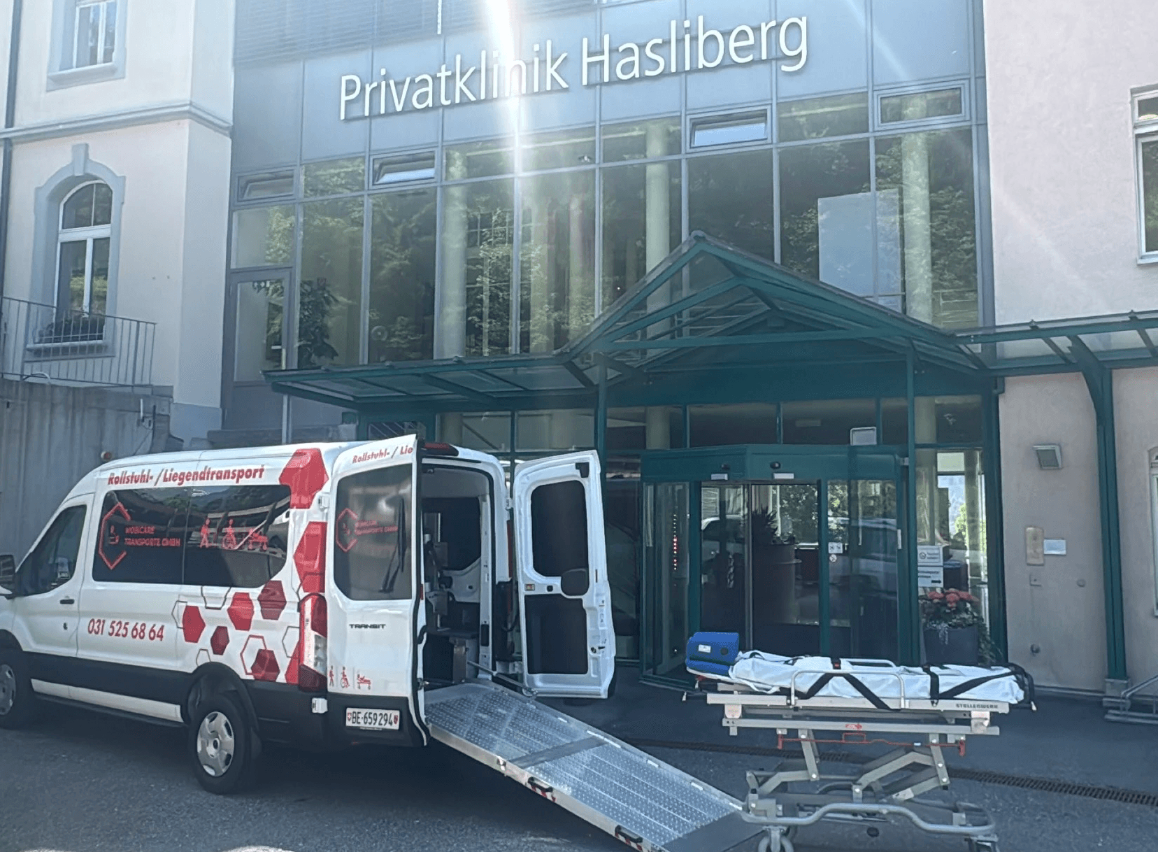 Fahrzeug von MobiCare Transporte mit Trage für den Liegendtransport vor einer Klinik