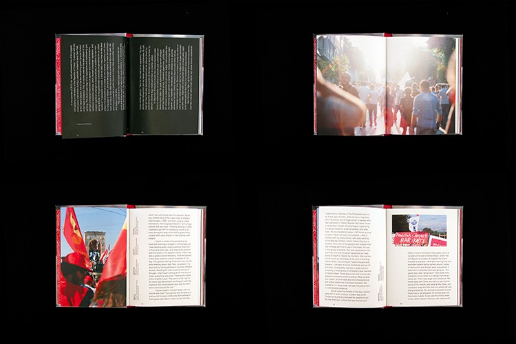 The image shows four open books arranged in a 2x2 grid against a black background. Each book has a red spine and contains text and photographs. The top left book has black text on a dark green or black background. The top right book shows a photograph of a crowd of people. The bottom left book features a red flag and a photograph of a person. The bottom right book displays a photograph of a sign with text. Each book is open to a page displaying text and images.