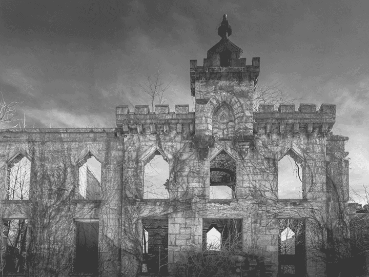 A dark, silhouette of a gothic castle or ruin under a stormy sky, representing the 'Building a Villain from Scratch' blog post.