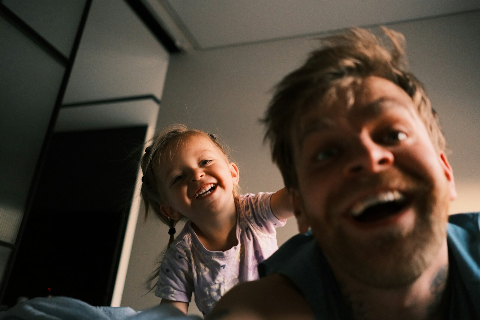 Father and daughter laughing together at home