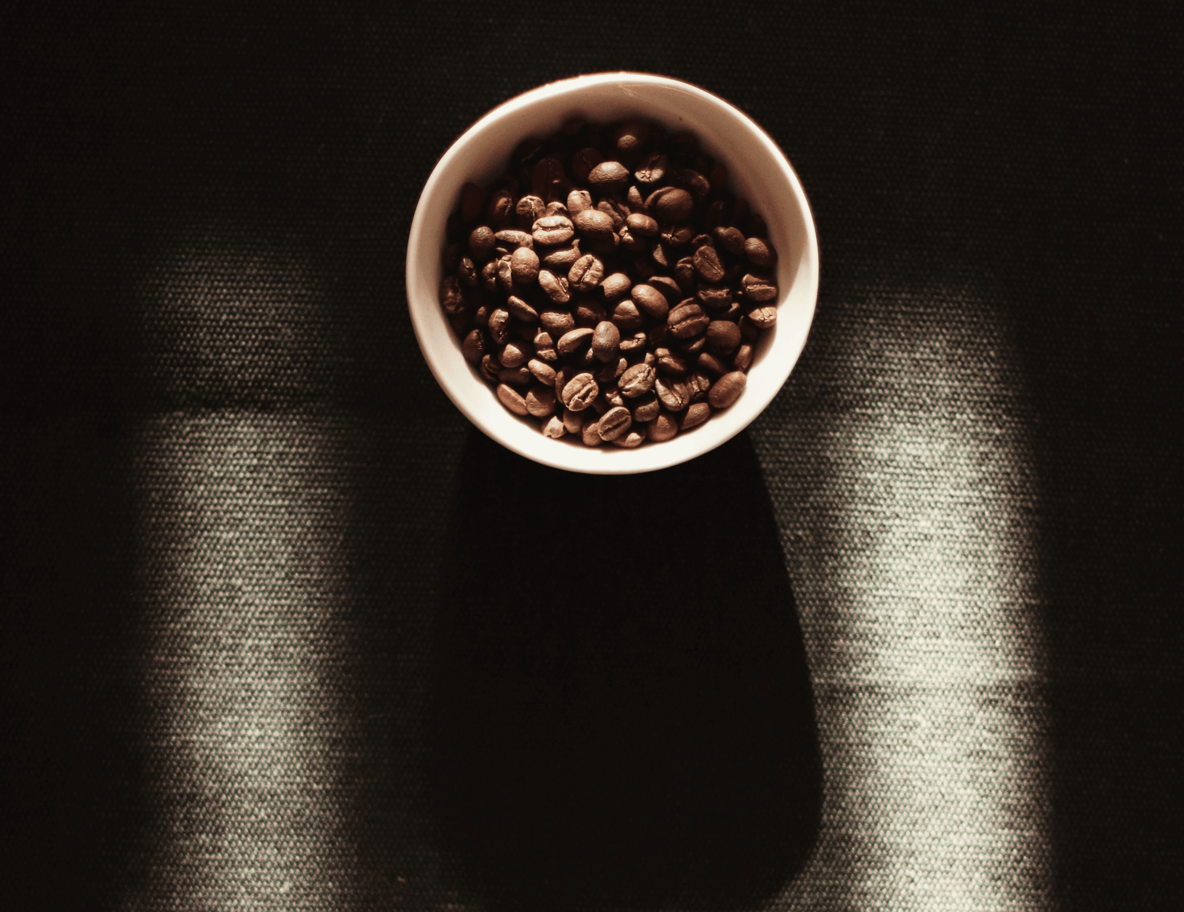 white ceramic mug with brown liquid inside