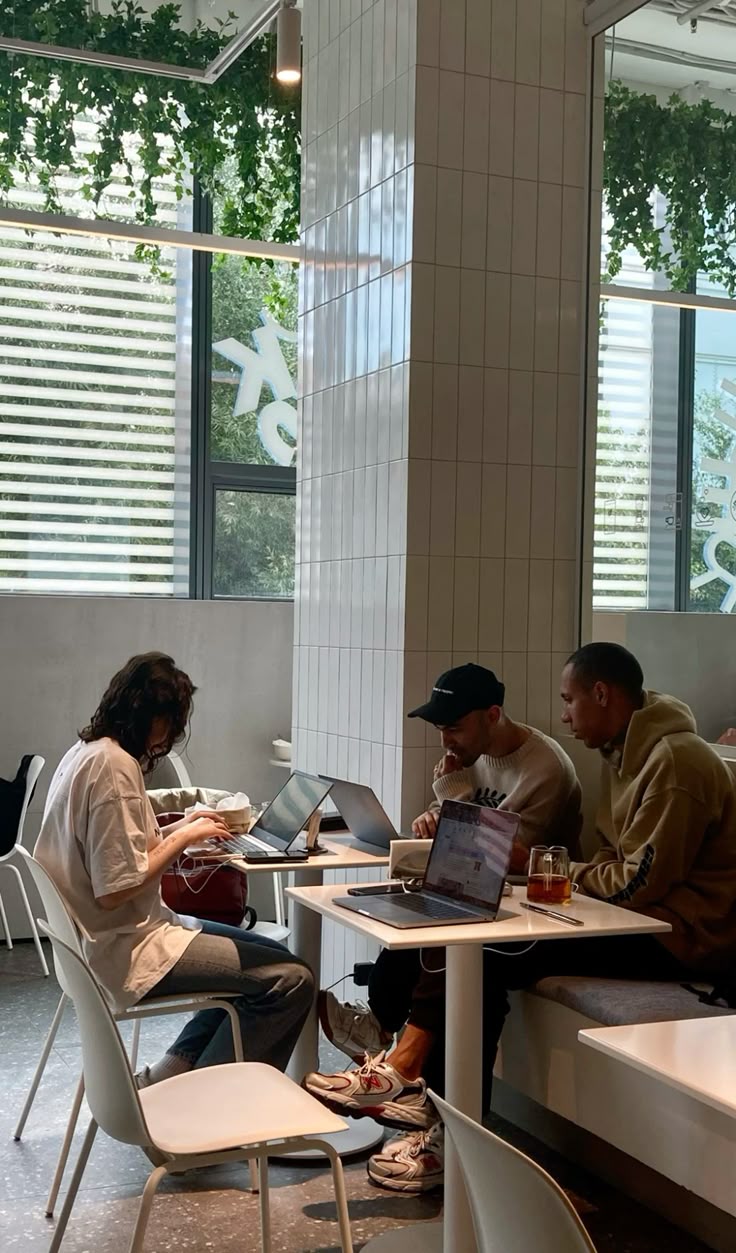 men sitting in front of their laptop computer