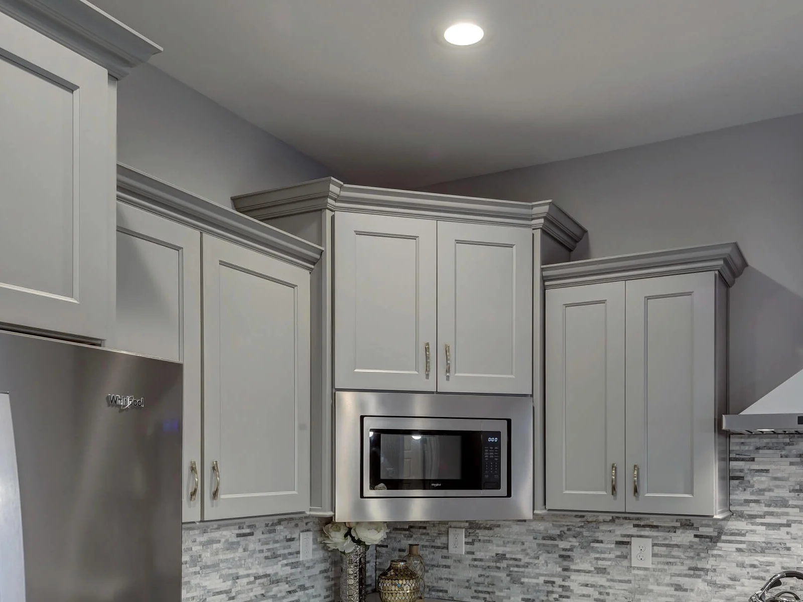 Brooklyn Gray upper cabinets with a range hood and microwave