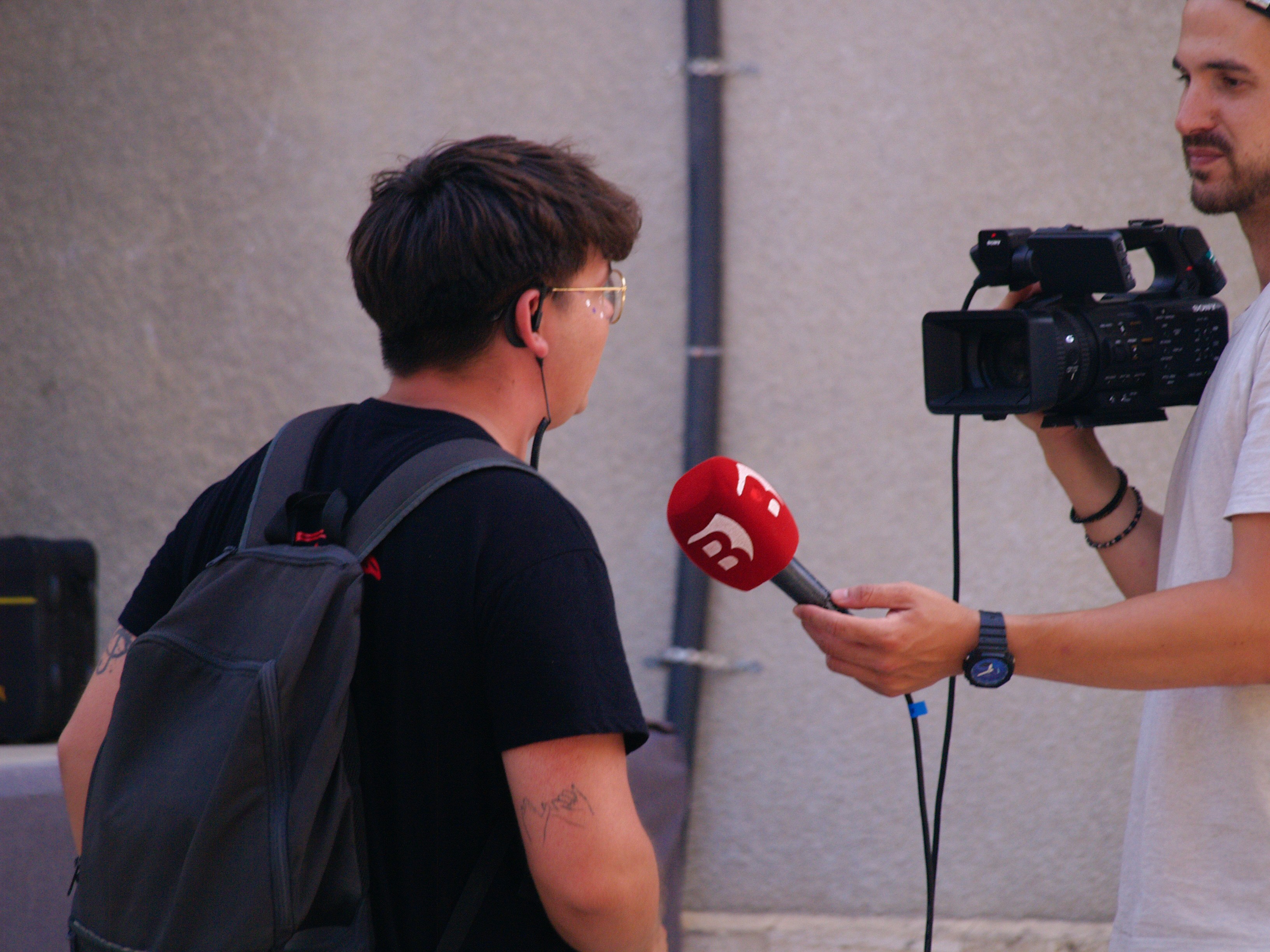 A person being interviewed with a microphone and camera