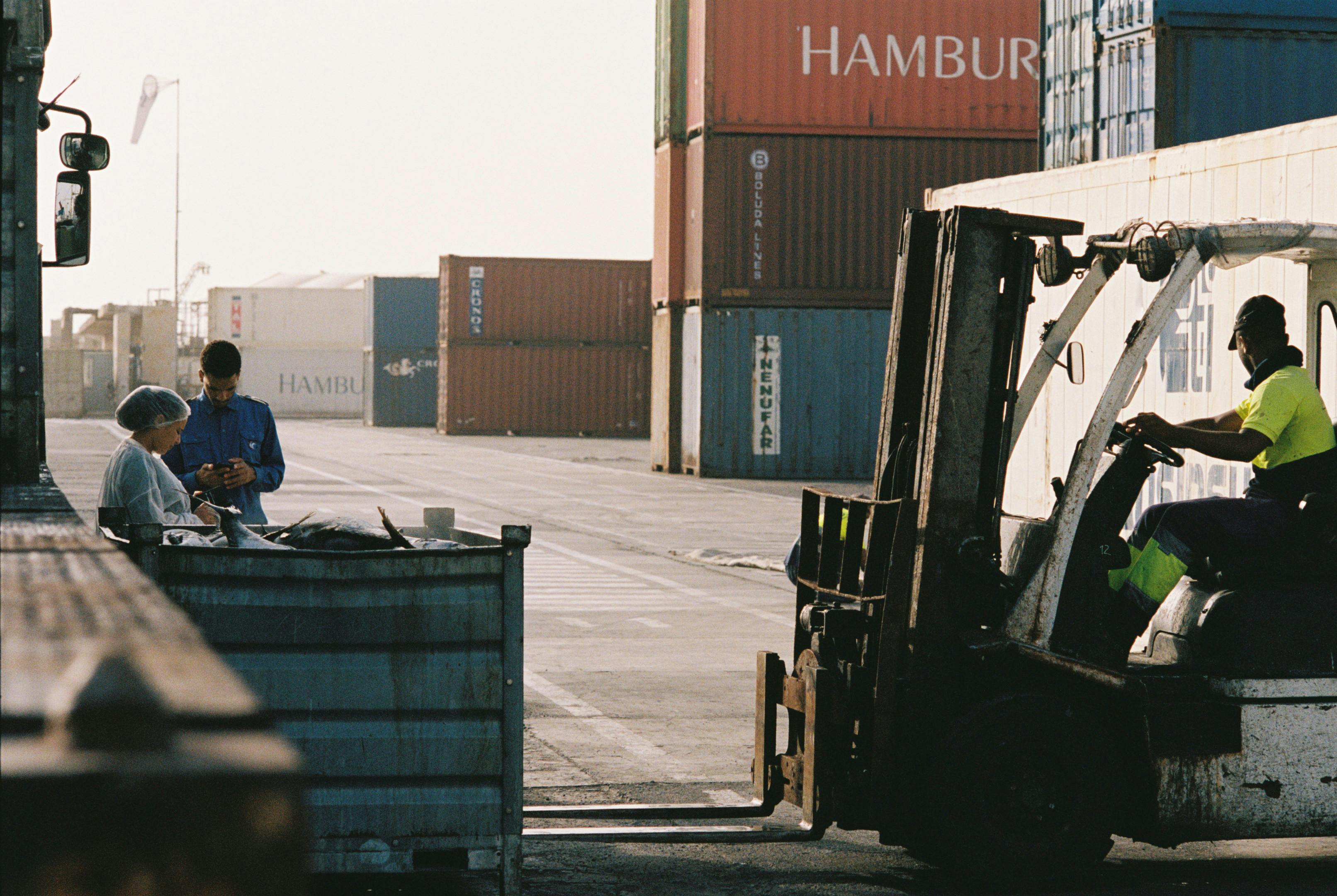 men and women operating forklift on port