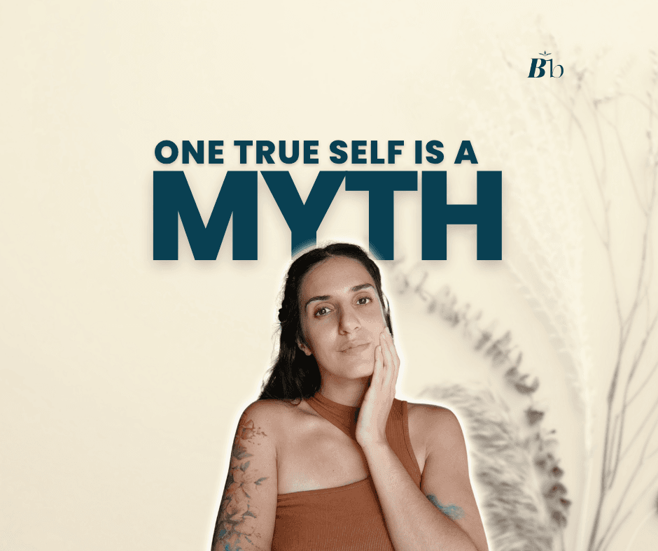 A woman is standing, looking self condifent, staring at the camera with her hand gently touching her cheek. The caption reads "One True Self is a MYTH"