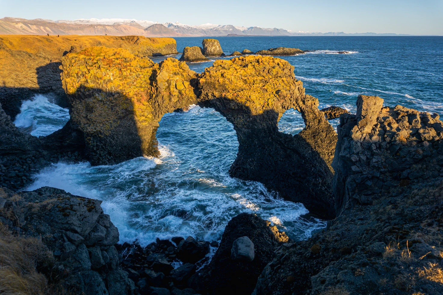 A cliff in the sea in the shape of a circle bridge named Arnarstapi in Iceland