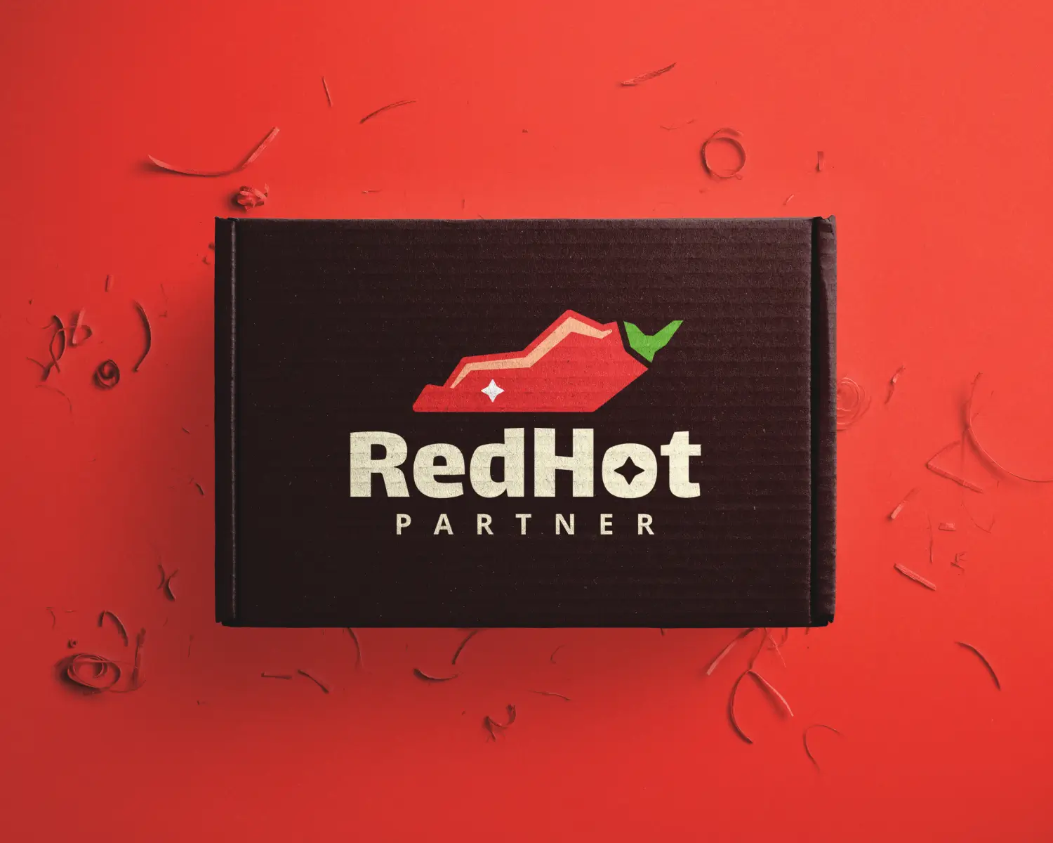 Black box on a red background with a logo of a red hot pepper and green stem. Text reads "Red Hot Partner." Energetic and bold design.