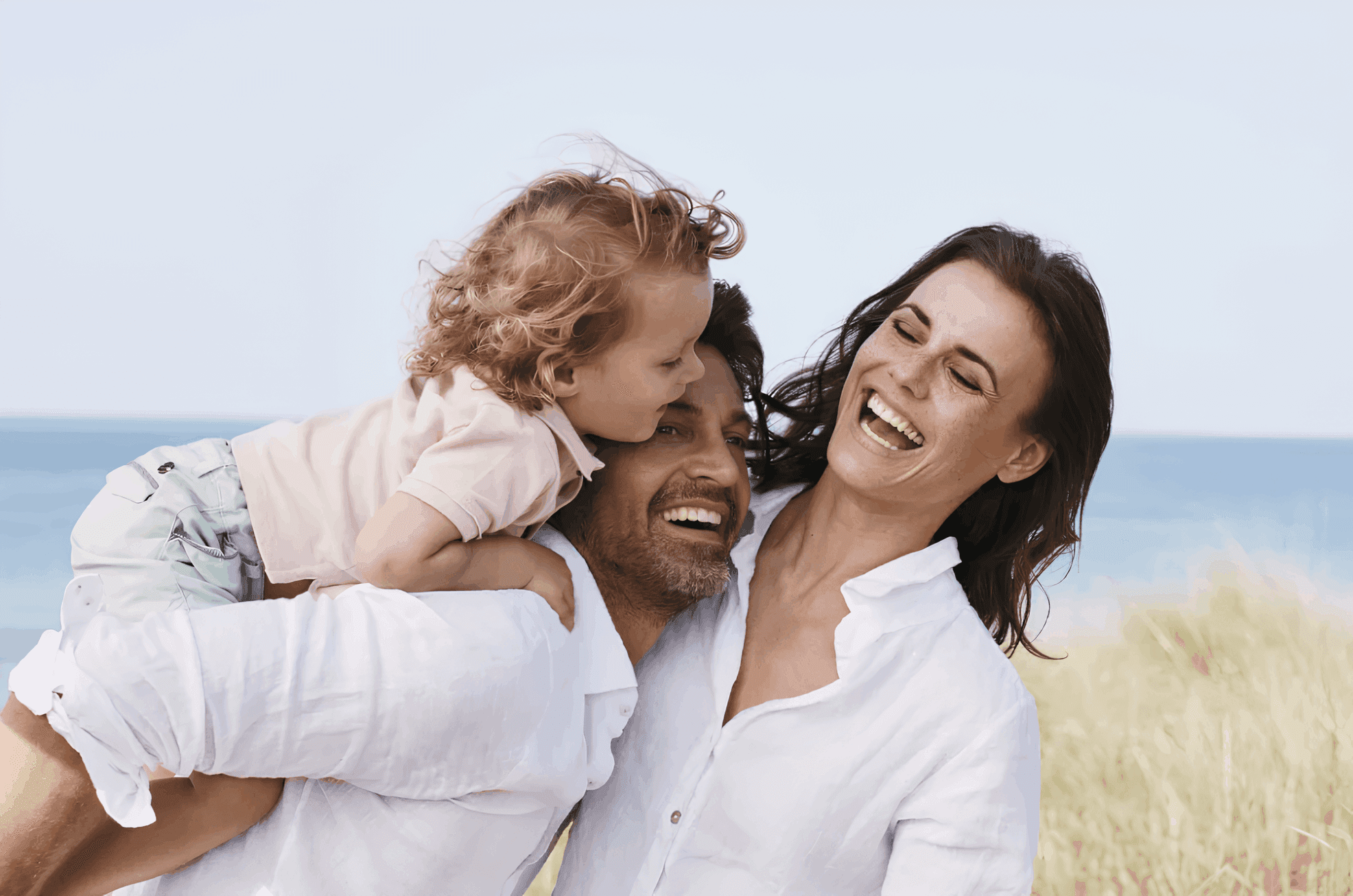 woman holding a phone and man looking at the phone. both are smiling