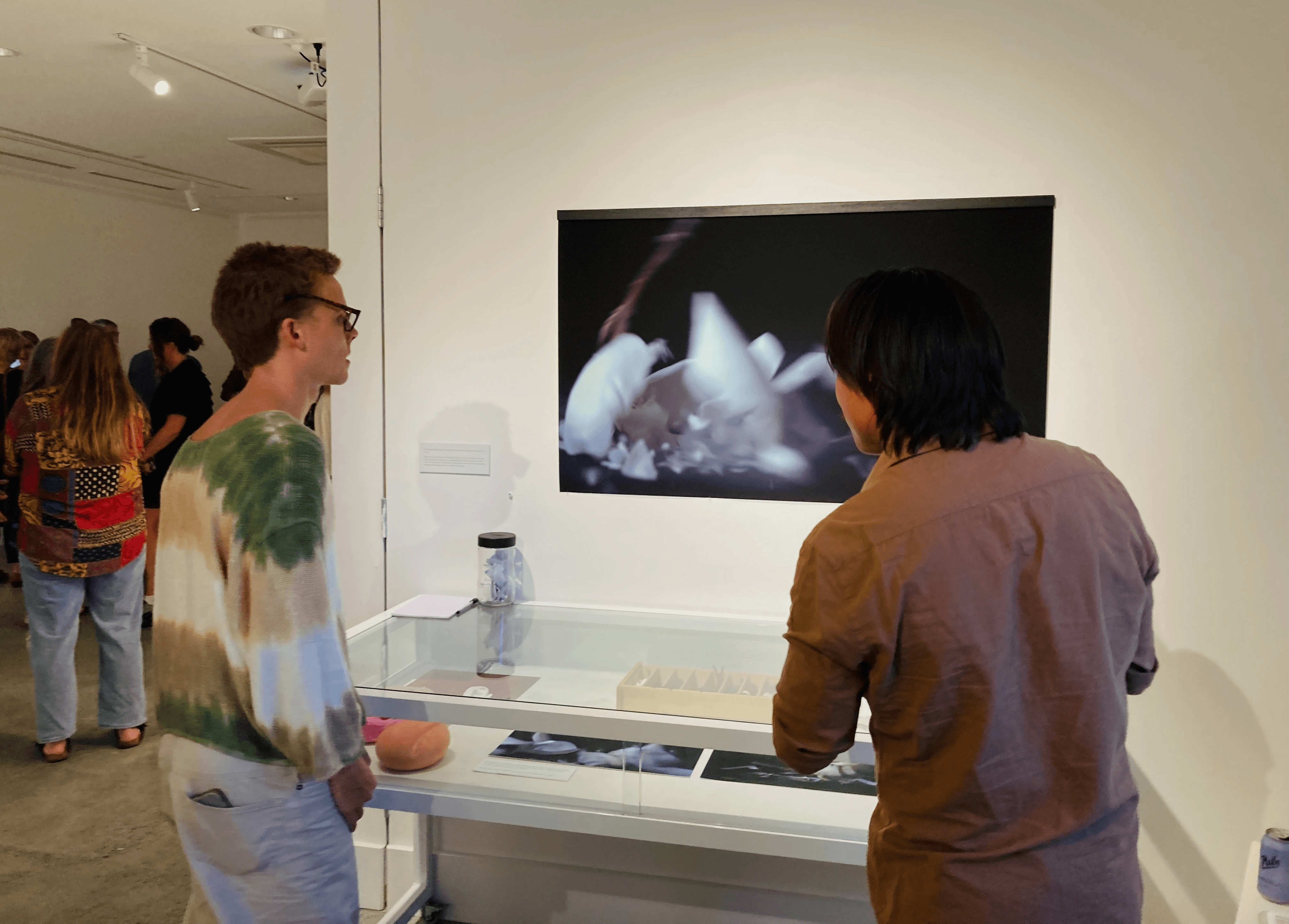 People looking at a projected work in a gallery