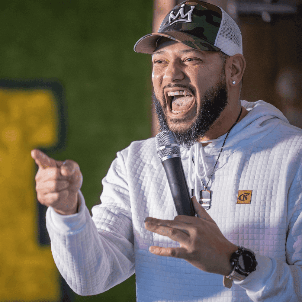 A man pointing and laughing on stage at a St Pete Standup show