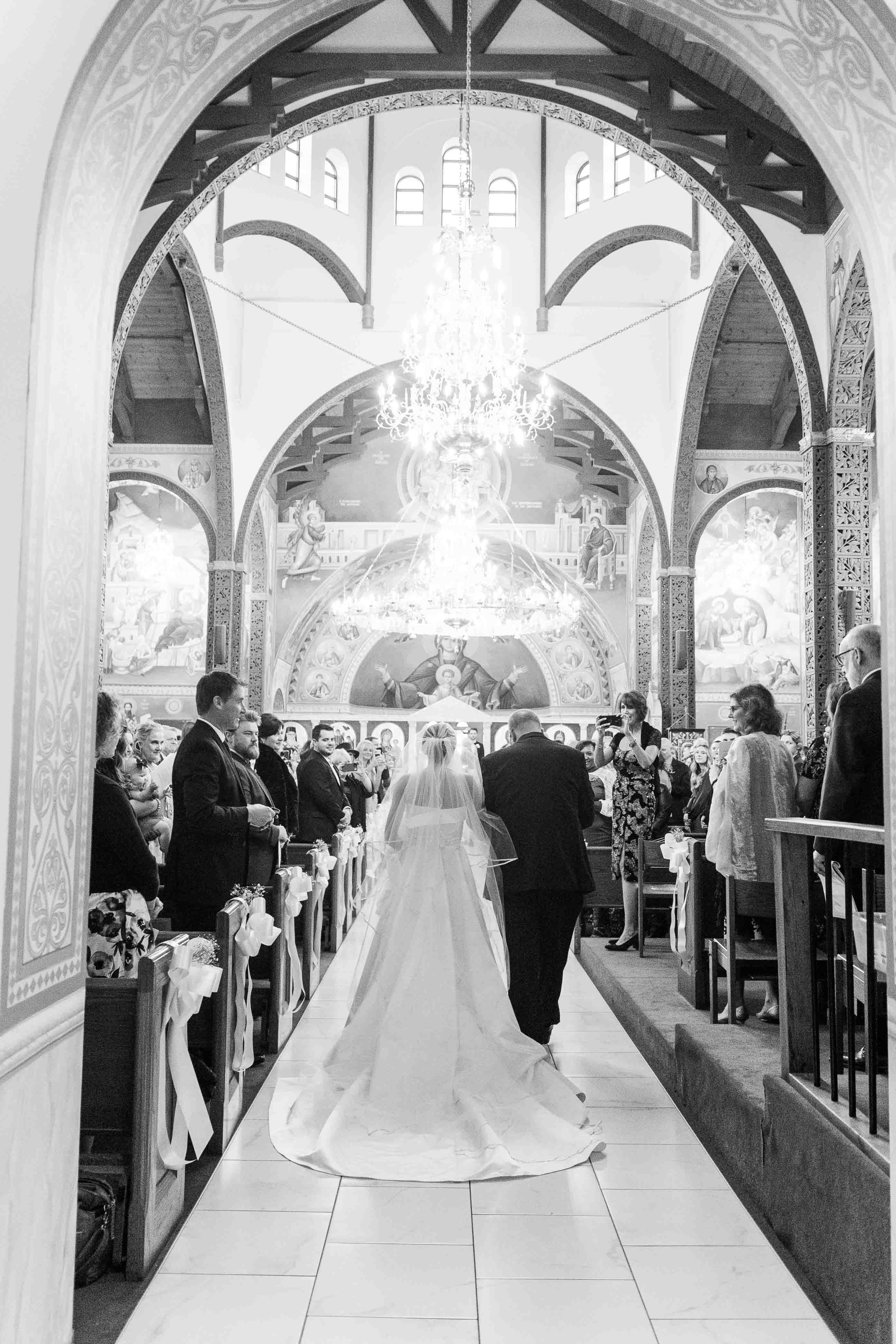 Black and white image of bride walking down the aisle in Nashville Tennessee
