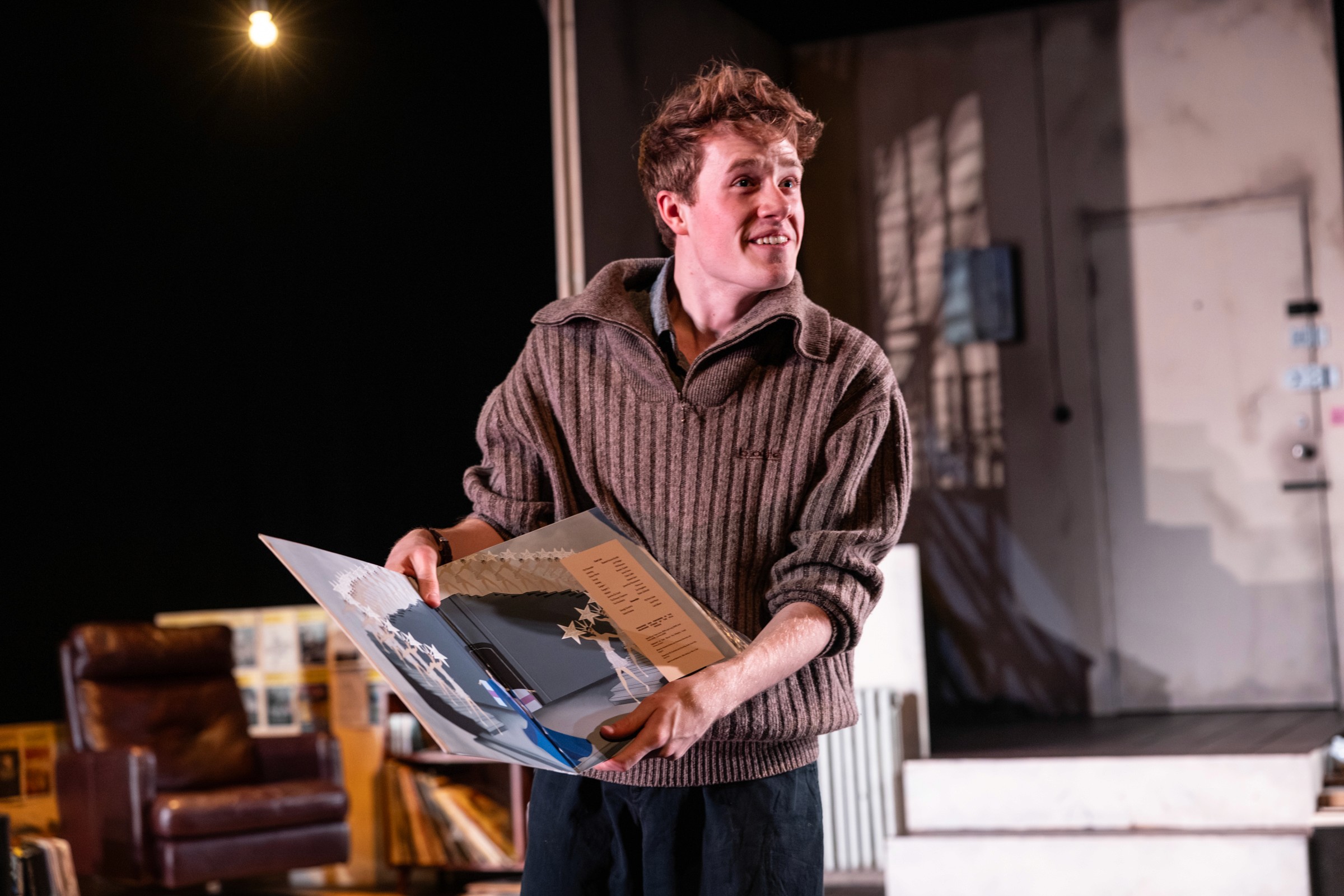 Man in chair introducing the show