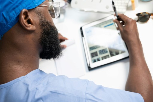 a man using a tablet illustrating the health insurance
