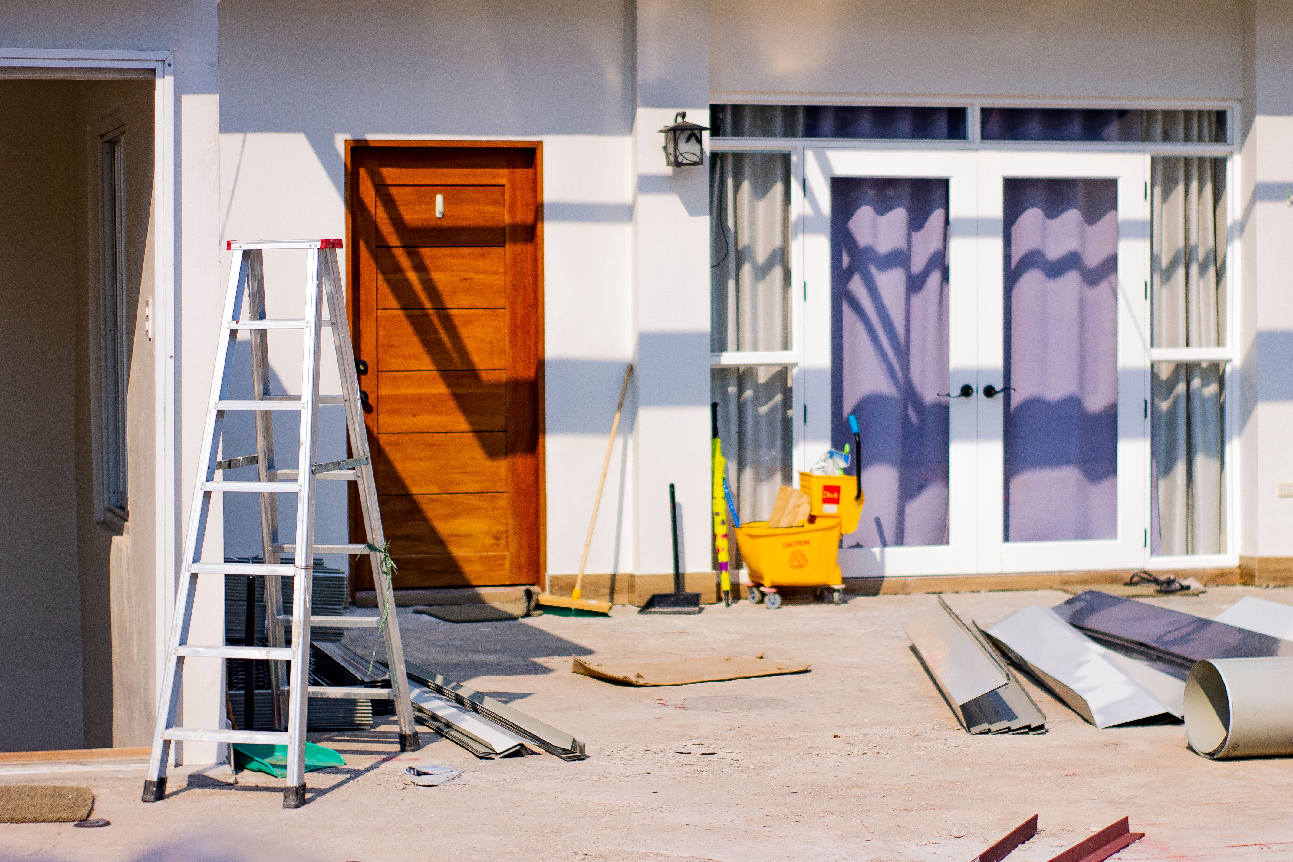 propertyu under rapair with ladder and materials in front of the house.