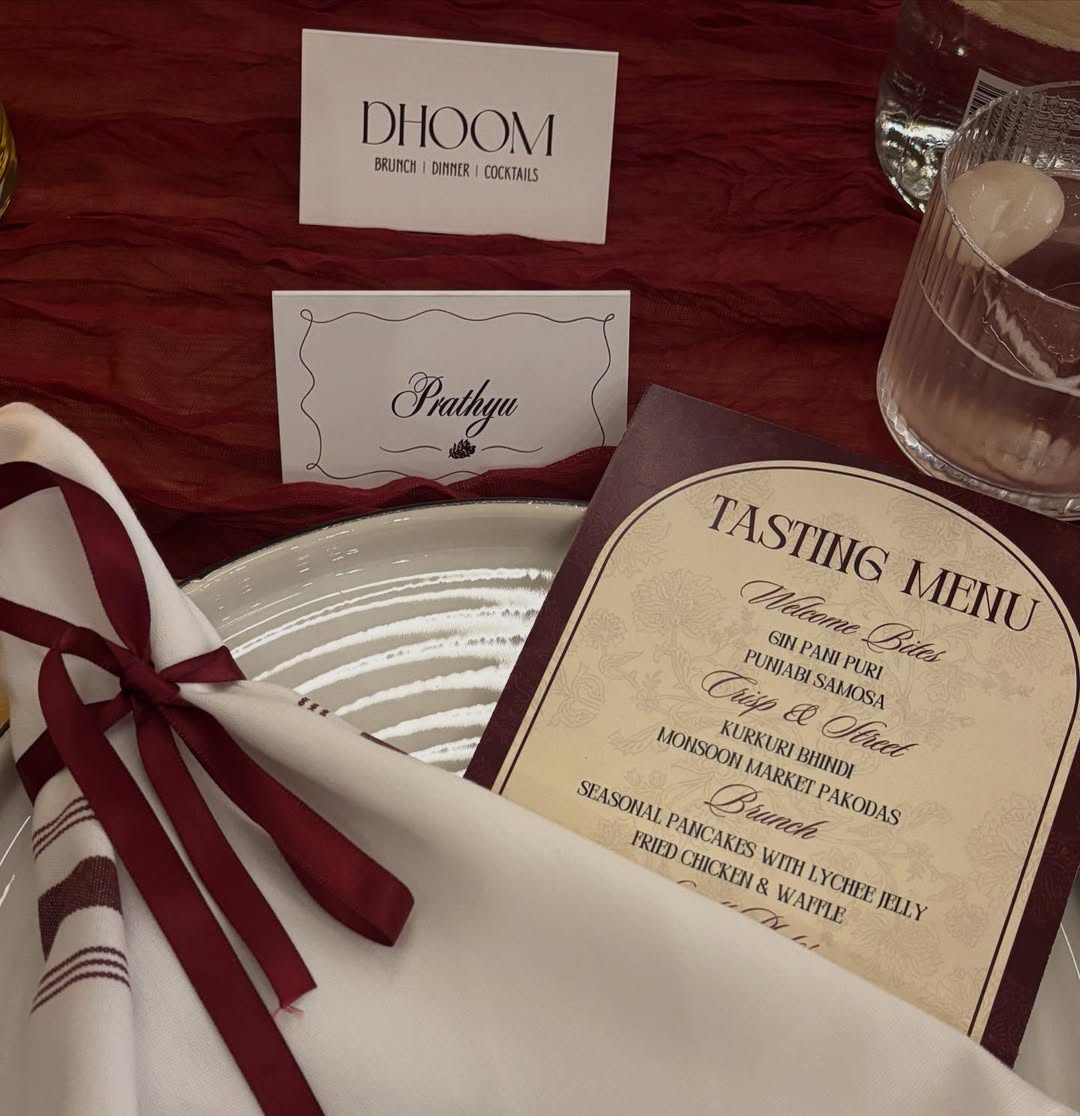 Dhoom tasting event table setting with personalized place card, curated tasting menu, and elegant dinnerware at an intimate pre-launch evening in Toronto.