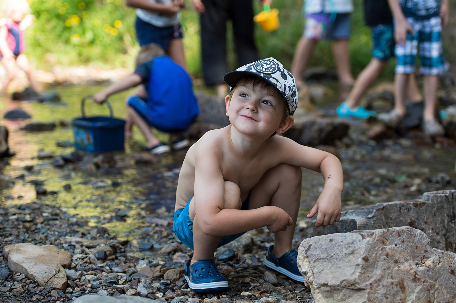 Child searching in the creek by the gemstone
