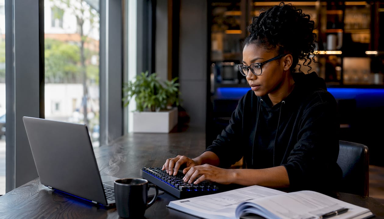 Side profile of IT engineer typing at desk