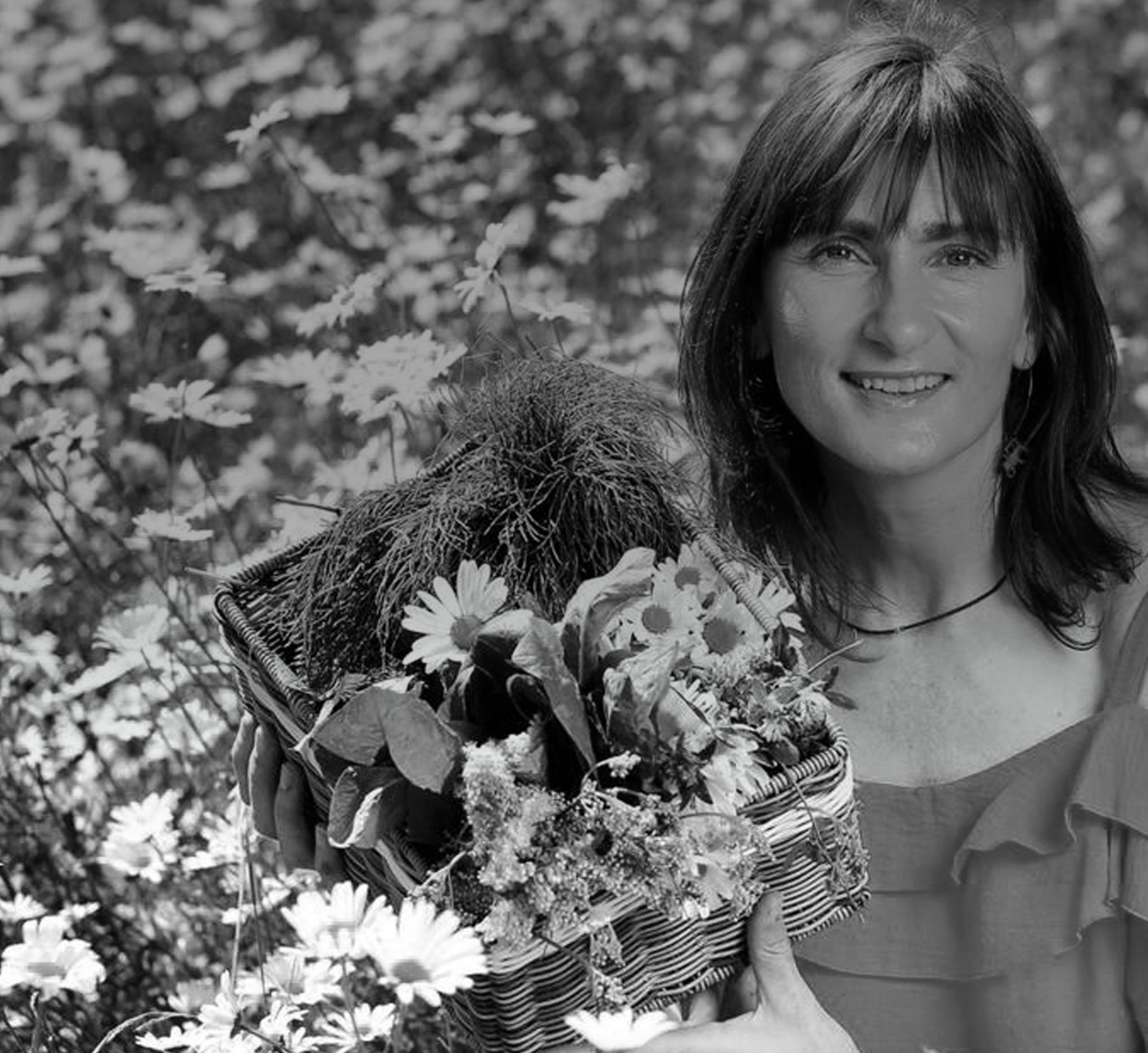Owner of Intelligent Tea standing in a field of flowers and laughing while supplying their goods to As One Restaurant Dubliln