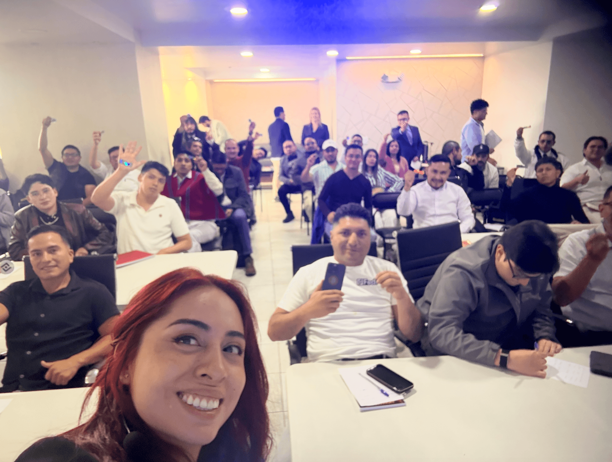 Fedi's Lorena Ortiz takes a selfie with a room full of smiling attendees at a JJ Chagerben and Fedi Bitcoin event in Quito, Ecuador.
