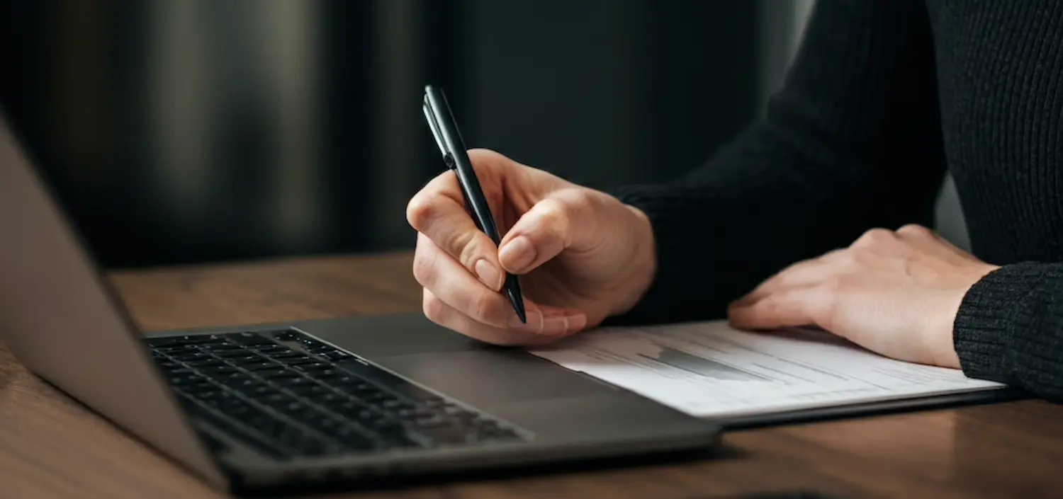 Person taking notes during an online therapy session in New York City with a licensed online therapist
