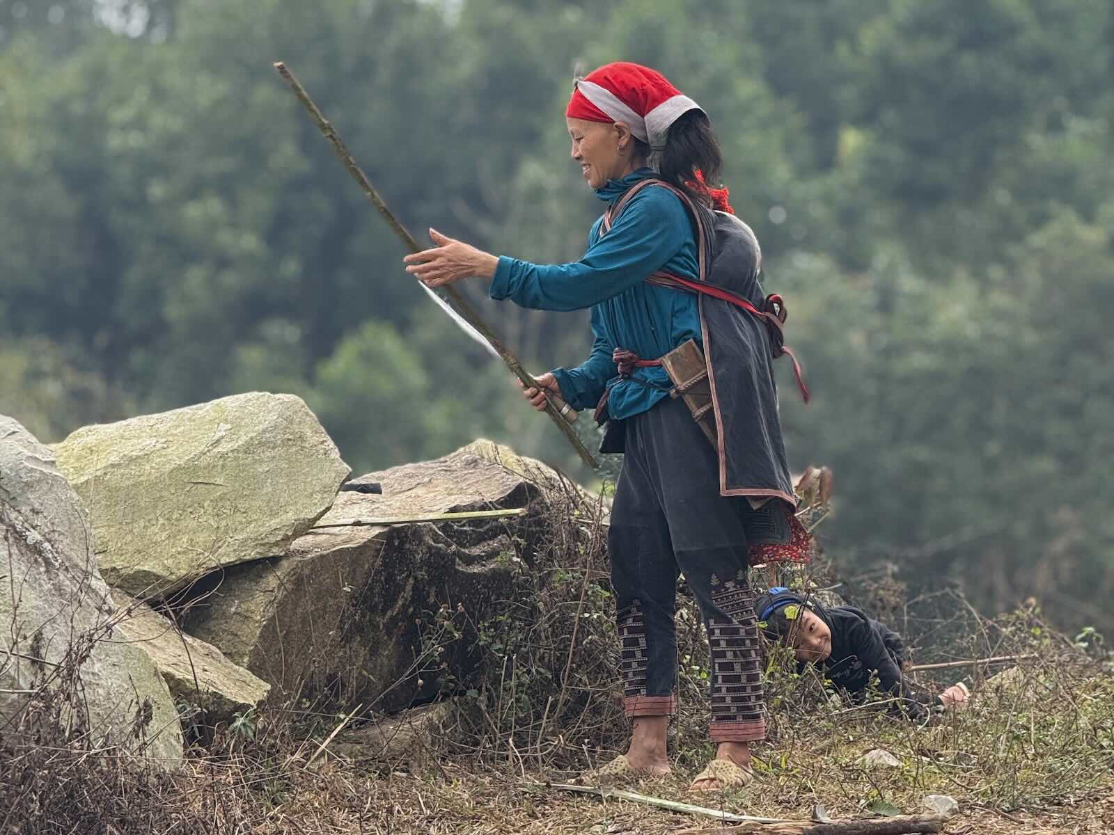 Red Dao woman and child during daily life activities near Ta Phin