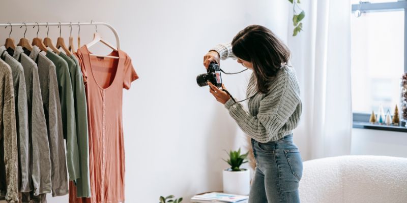 A retail business owner taking photos of her products