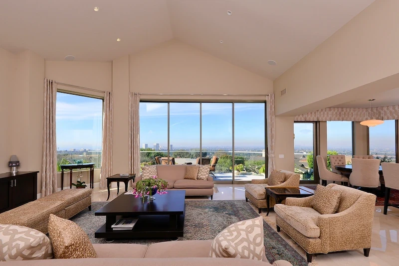 Harbor Ridge Transitional Remodel living room with vaulted ceiling and panoramic city views.