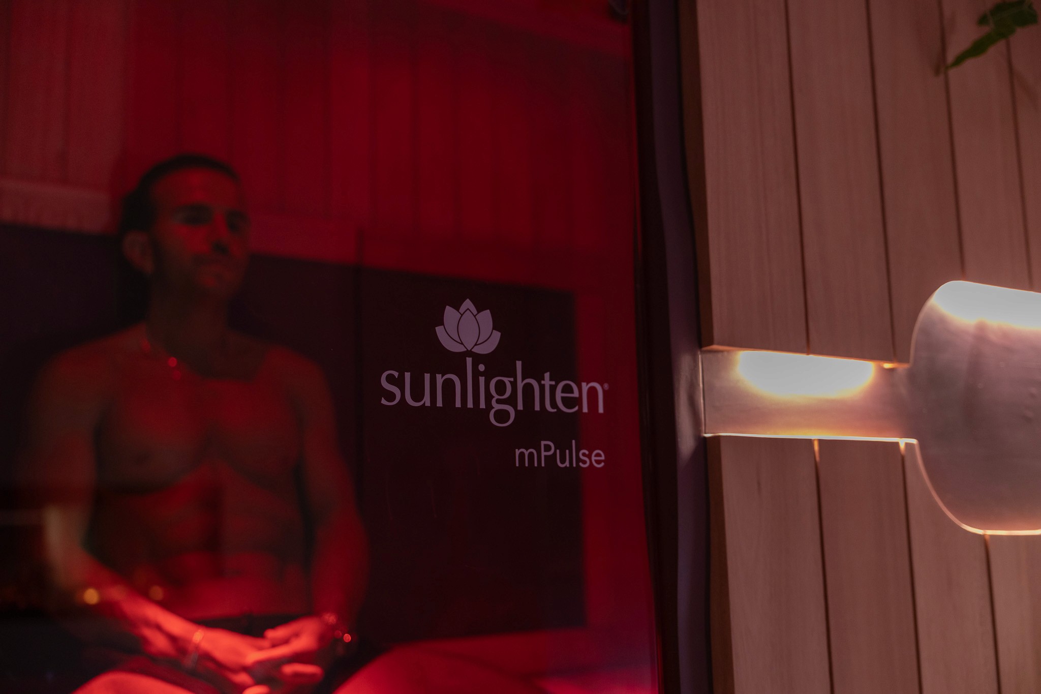 Rachel, personal trainer, looking to the side confidently in a fitness studio