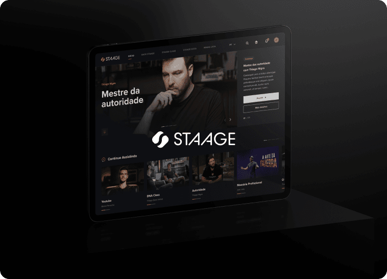 Modern red brick apartment or office building viewed from below against a blue sky, showcasing its geometric architecture with evenly spaced windows and balconies.