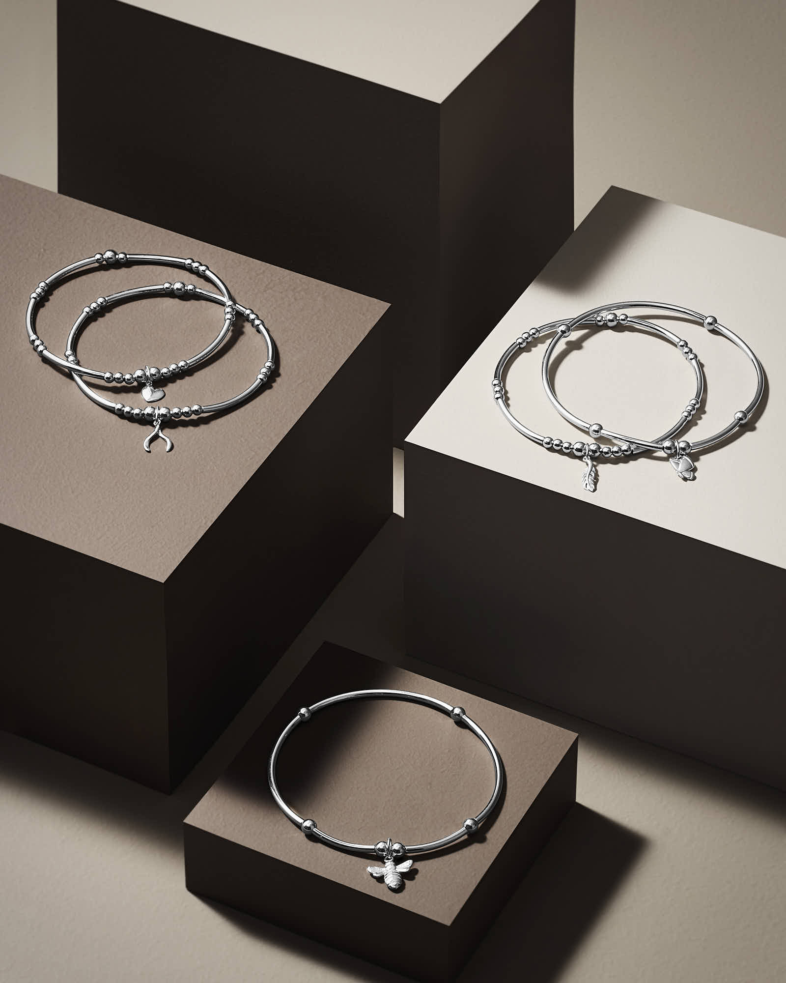 Two elegant jewelry boxes in black and white, each displaying a simple circular design on the lid.