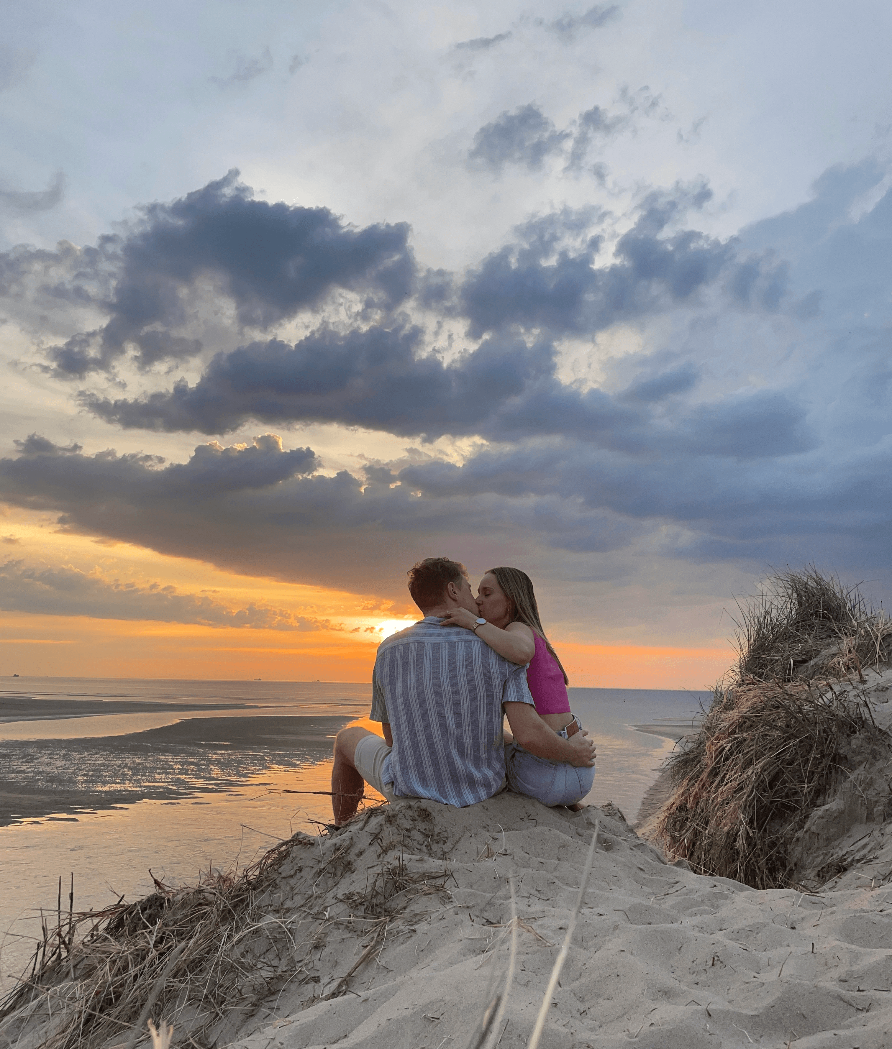 Two gold wedding rings rest atop a soft, textured fabric with a subtle pattern. The rings shine under gentle light, evoking themes of love and commitment.