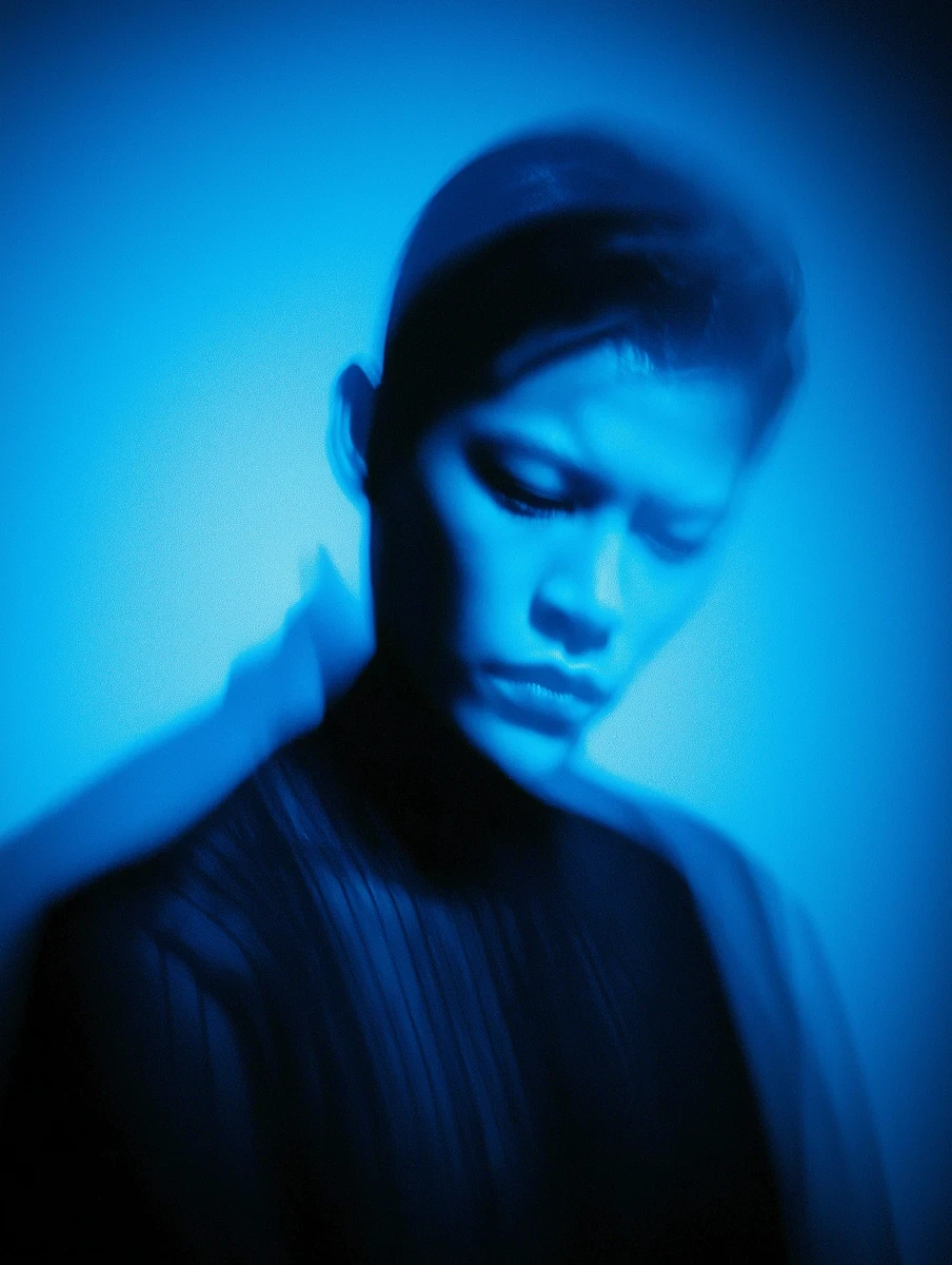 Hand silhouette holding a smartphone with a glowing red screen.