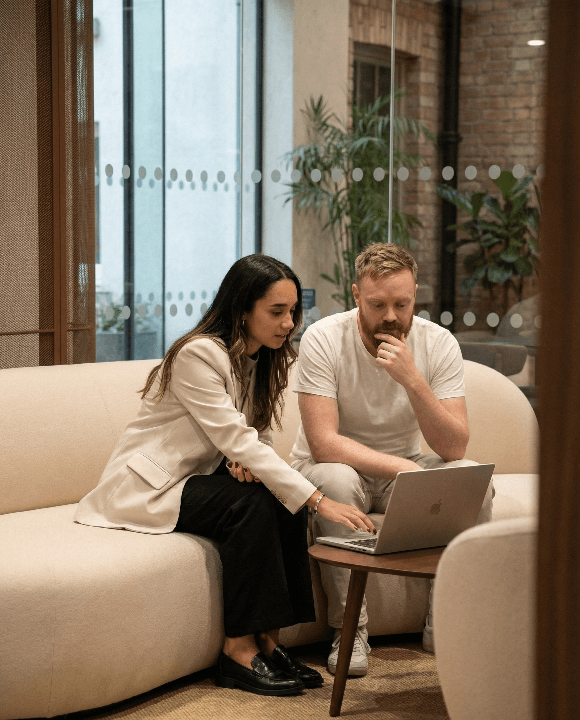 Abstract art of two faceless figures in red and black against a yellow background.