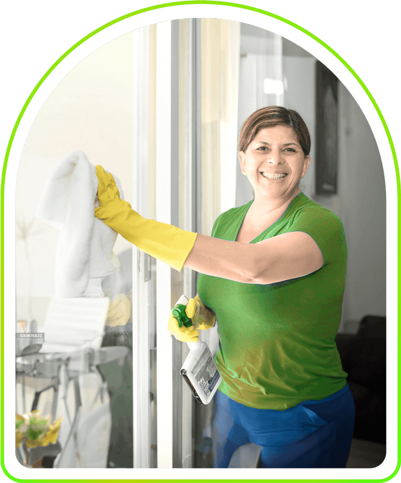 Justo Professional Cleaning employee cleaning a window pane