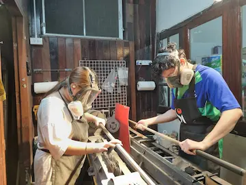 sunny akani and his sister finishing snooker cues in their workshop
