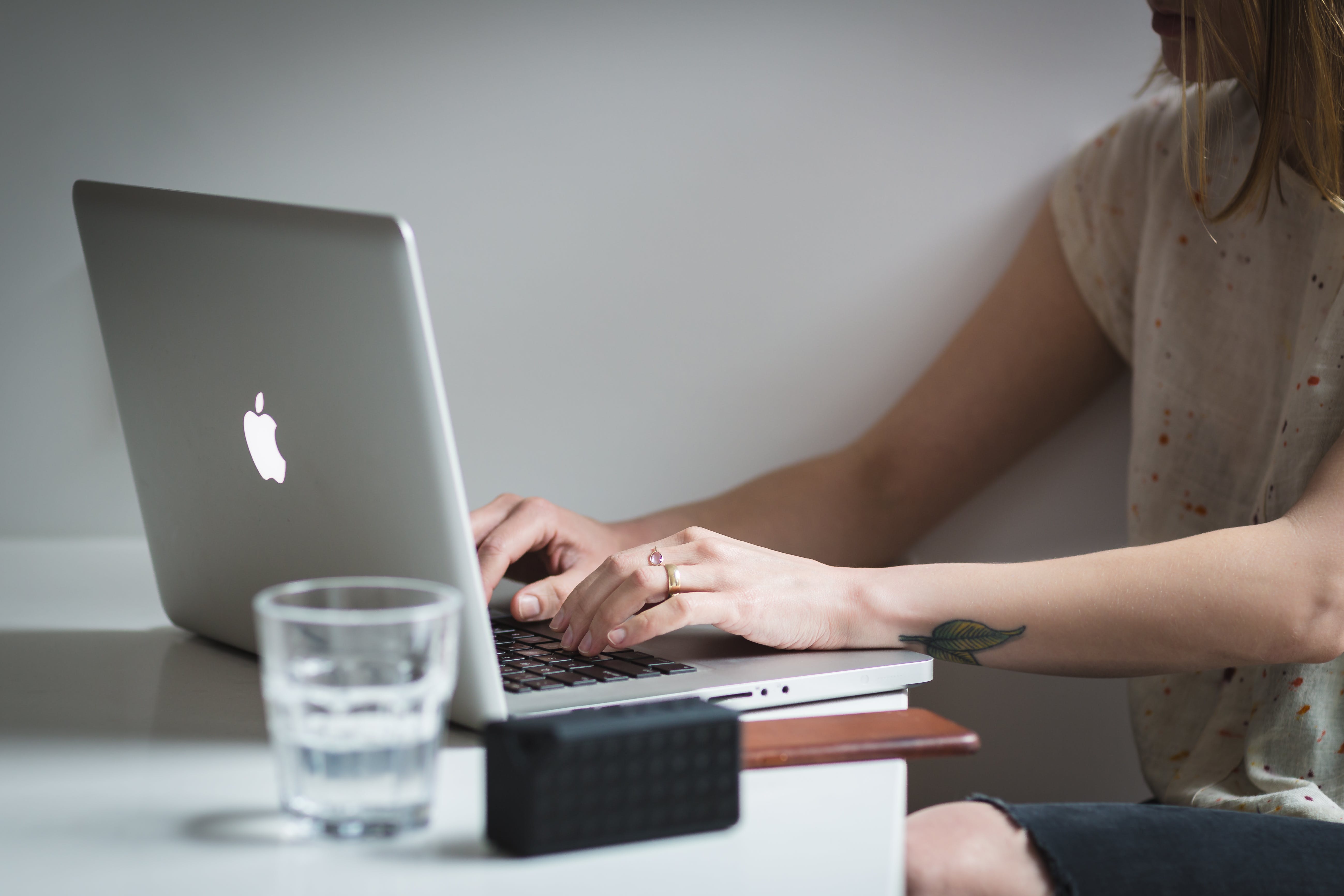 Adult writing emails on laptop while using effective outreach strategies