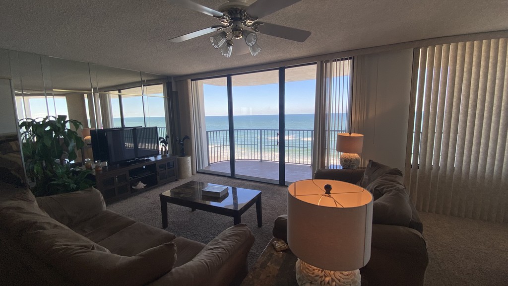 Living room with a TV, sofas and vertical blinds, Unit 1005 at The Ashley, a vacation rental in Daytona Beach Shores