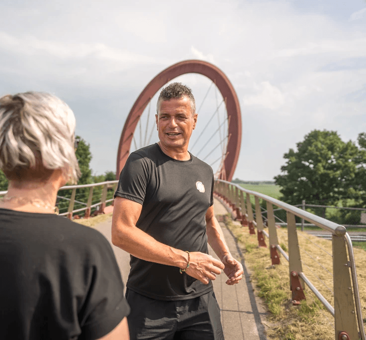 Snowboarder enjoys a downhill run on a sunny day.