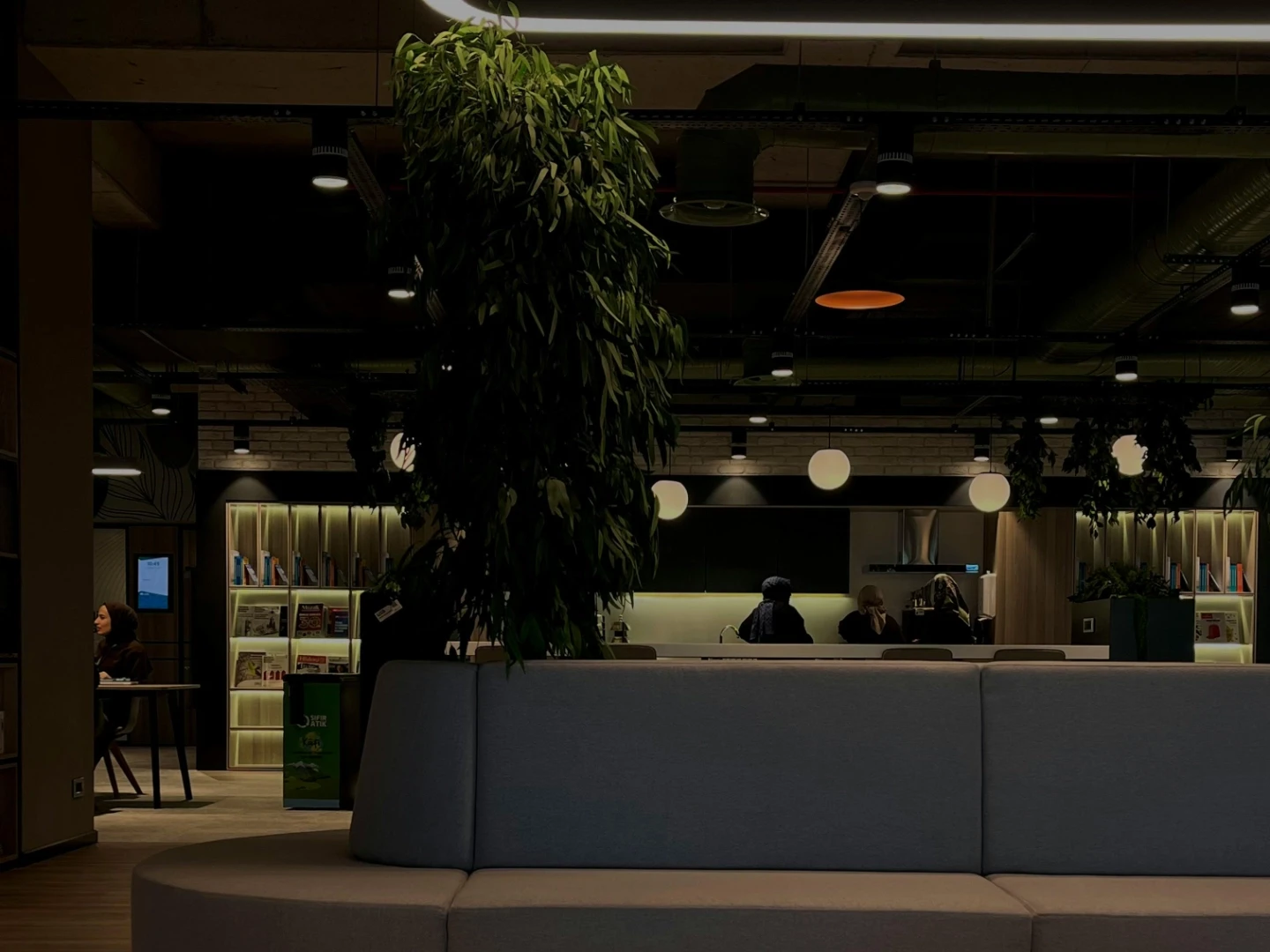 A purple-toned abstract scene featuring a geometric shape and a sphere on a table.