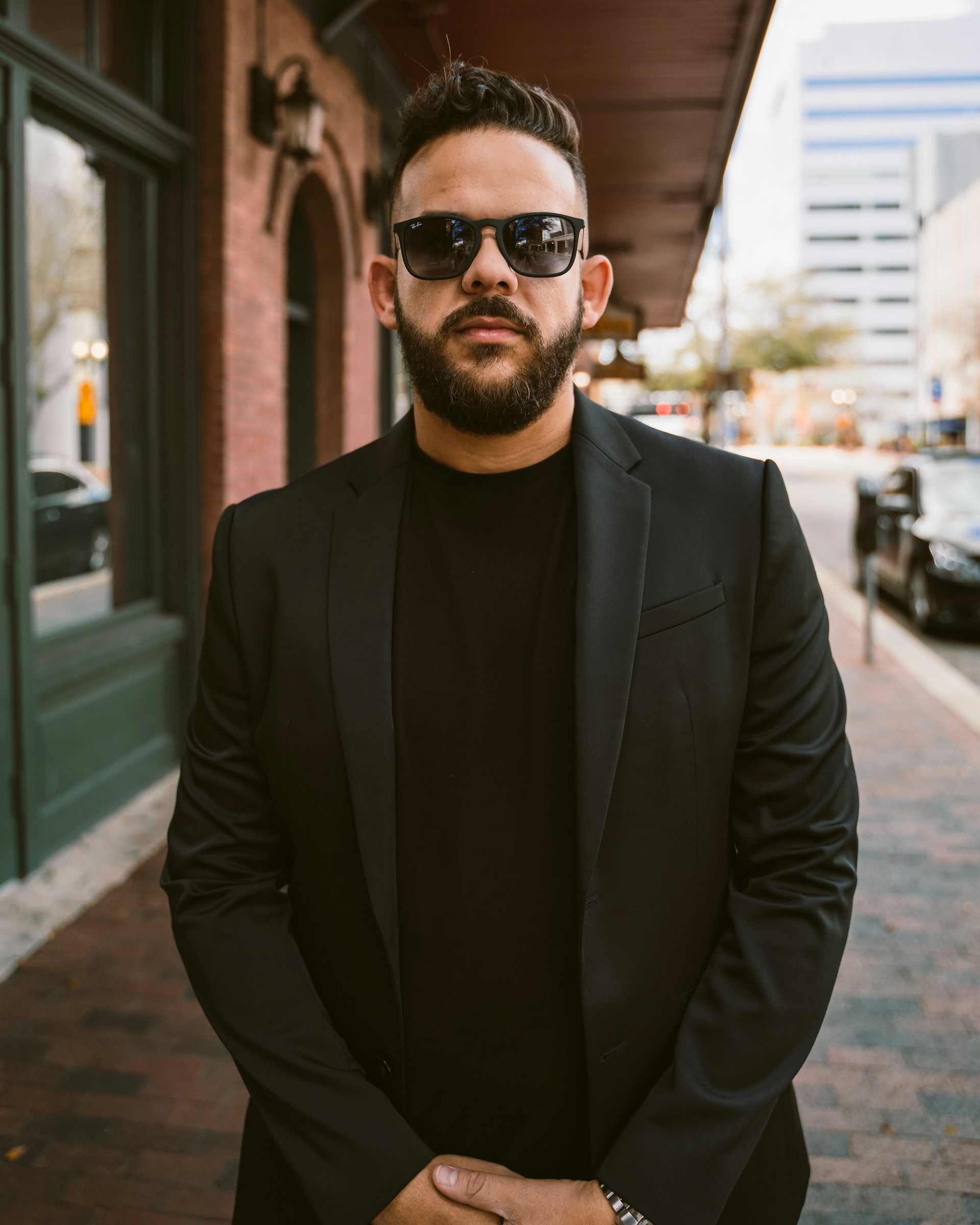 Confident Man with sunglasses and wearing black.
