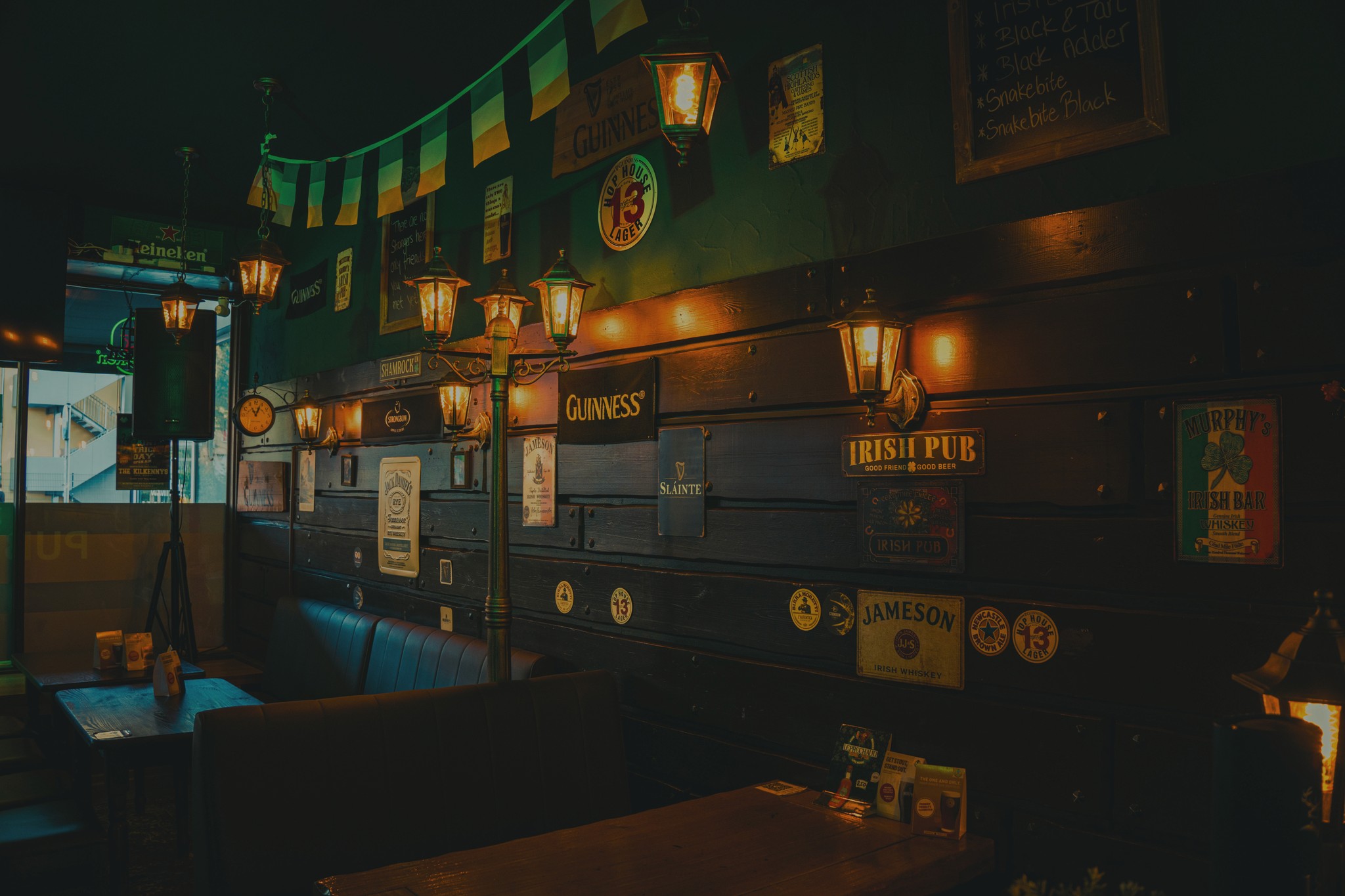 A dimly lit bar scene with warm yellow lights, creating a cozy and inviting atmosphere.