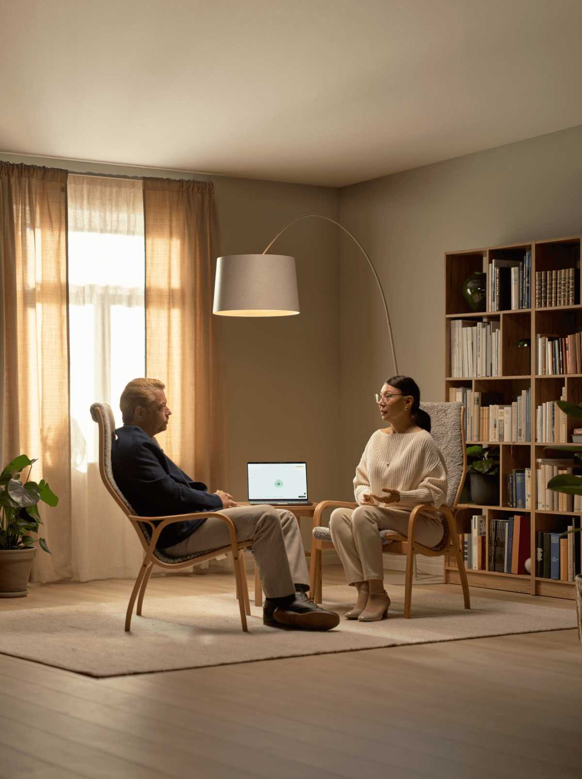 Patient consultation at a desk with laptop