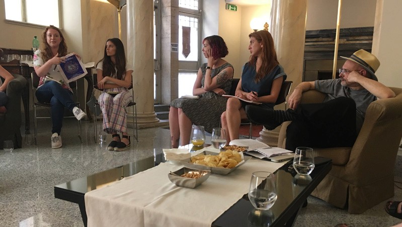 A photo of a group of students sitting around a coffee table.