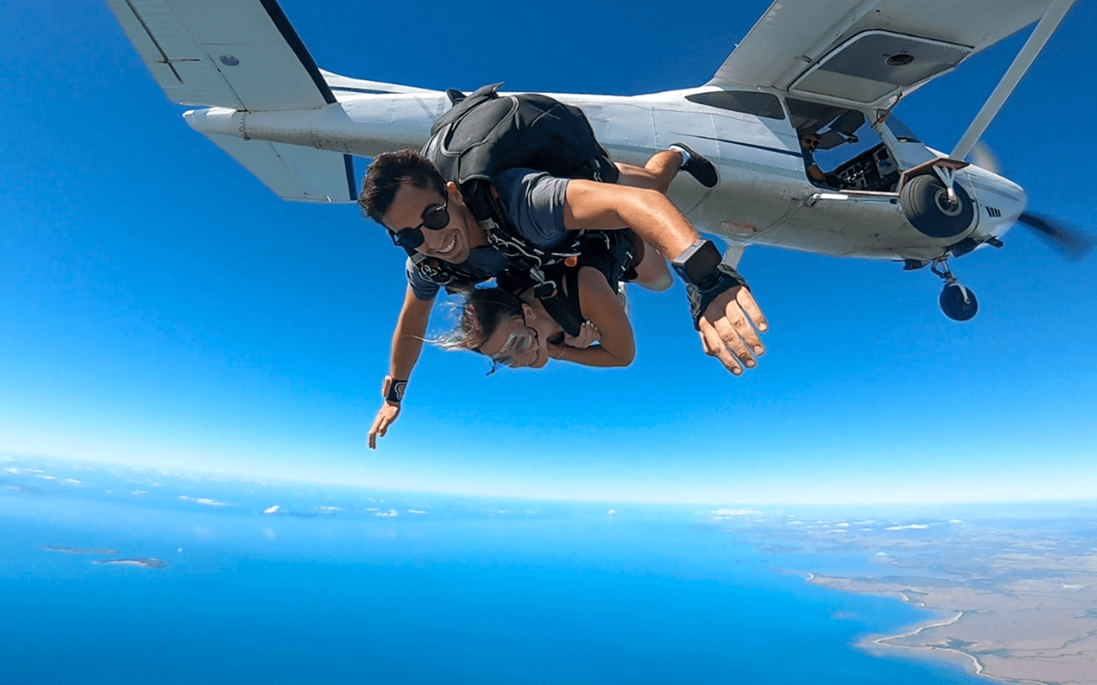 Tandem skydive over Airlie Beach with ocean view and beach landing.